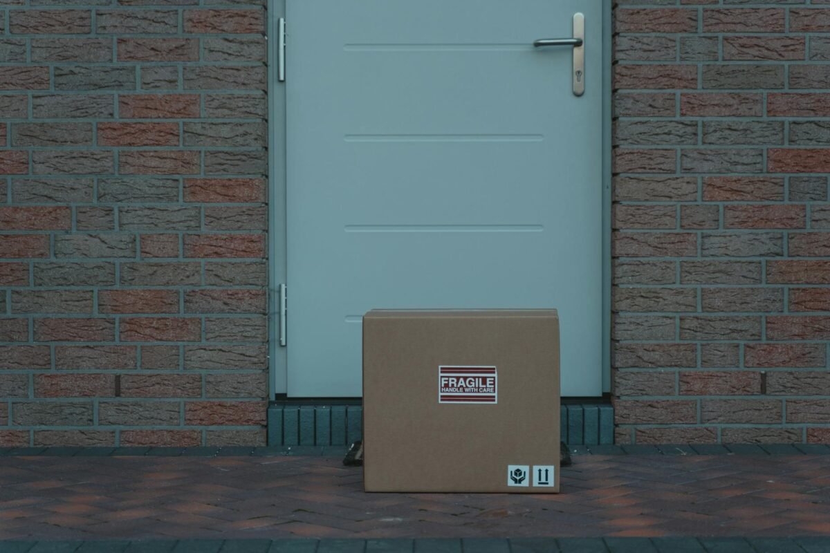 a brown cardboard box beside white door